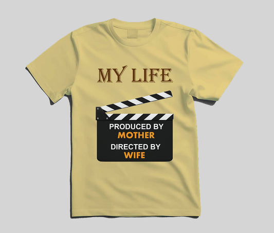 A pale yellow short-sleeve t-shirt with a graphic print on the front. The graphic features the text 'MY LIFE' in brown serif letters above a black-and-white clapperboard design with the text 'PRODUCED BY MOTHER DIRECTED BY WIFE' in white and orange lettering.