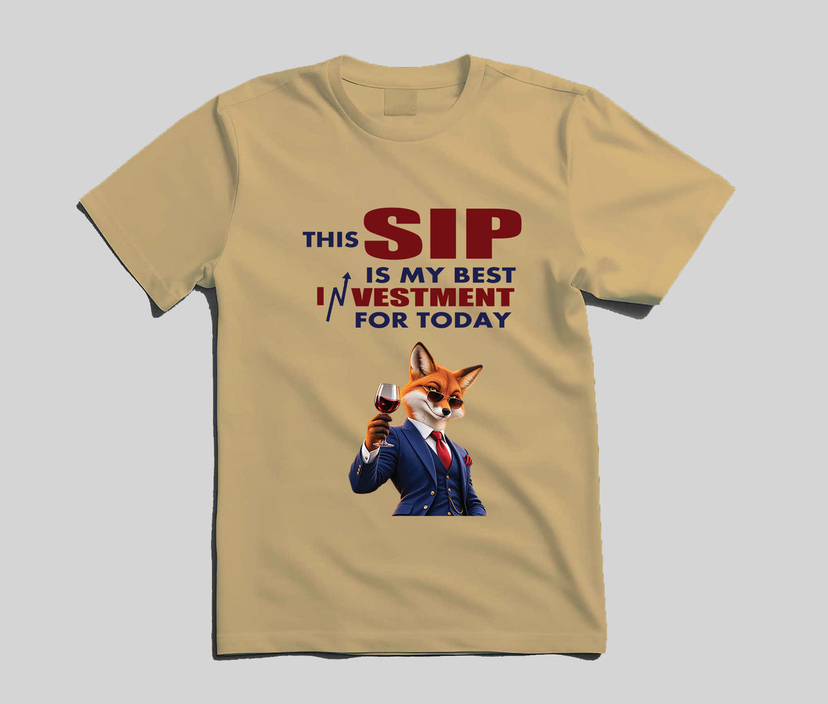 A beige short-sleeve t-shirt with a graphic print of a fox in a business suit holding a wine glass, accompanied by the text 'THIS SIP IS MY BEST INVESTMENT FOR TODAY' in red and blue lettering, displayed on a neutral gray background.