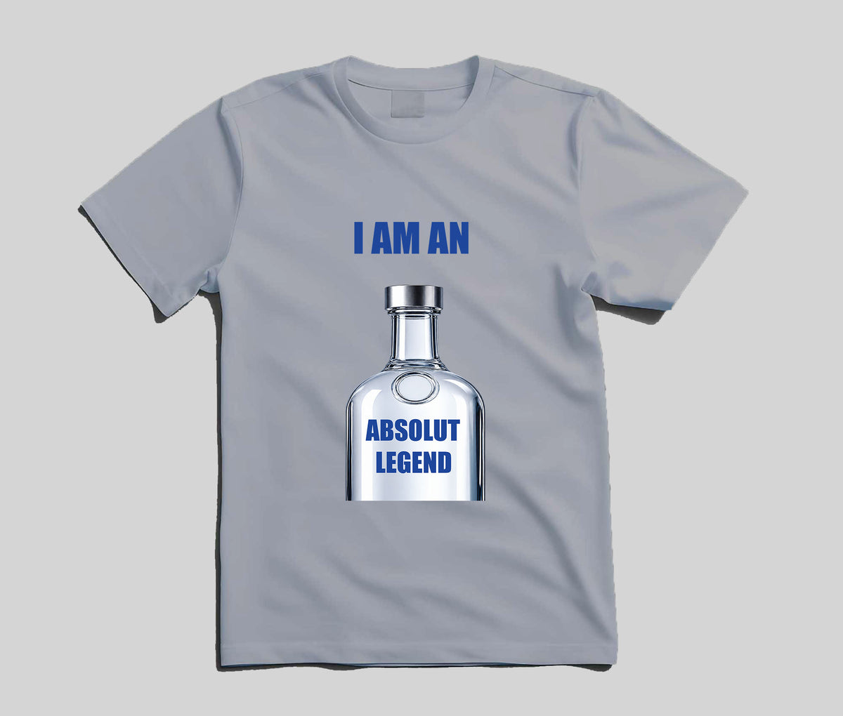 A light gray short-sleeve t-shirt with a graphic of a clear liquor bottle and blue text reading 'I AM AN ABSOLUT LEGEND' on a solid gray background.