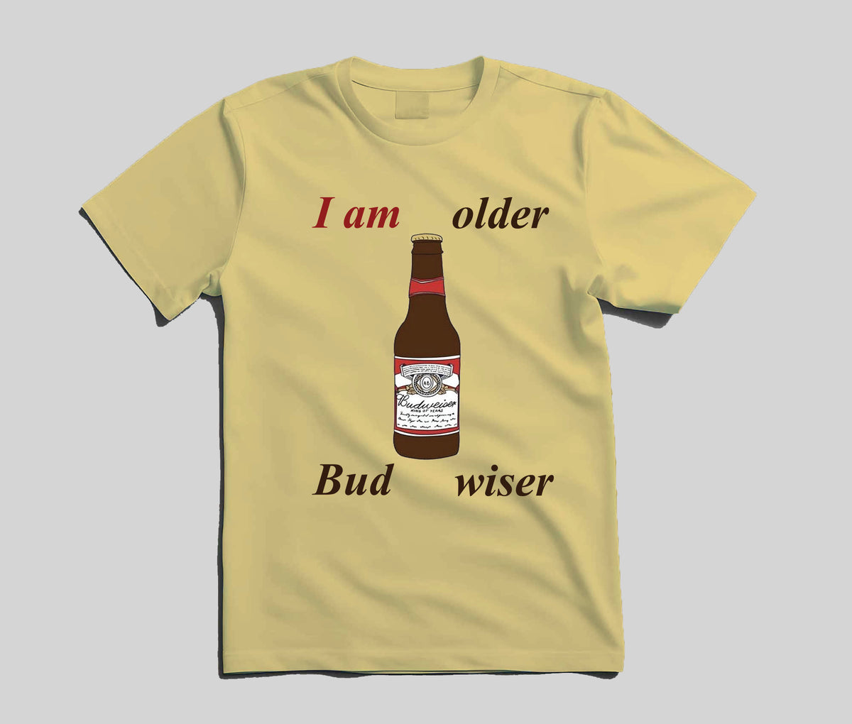 A pale yellow short-sleeve t-shirt with a graphic print of a Budweiser bottle and the text 'I am older Bud wiser' on a light gray background.