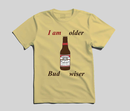 A pale yellow short-sleeve t-shirt with a graphic print of a Budweiser bottle and the text 'I am older Bud wiser' on a light gray background.